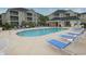 Community pool with ample lounge chairs, buildings in the background, and tables under a covered area at 2060 Cross Gate Blvd. # 305, Surfside Beach, SC 29575