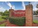 An elegant brick entrance displays the community name, Maddinton Place, surrounded by lush greenery at 2060 Cross Gate Blvd. # 305, Surfside Beach, SC 29575