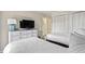 Bright bedroom showing two twin beds, dresser with television, and closet doors at 2805 N Ocean Blvd. # 214, Myrtle Beach, SC 29577