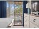 Bedroom with dresser and balcony access overlooking the pool at 2805 N Ocean Blvd. # 214, Myrtle Beach, SC 29577