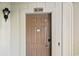 A close up of the unit 214 front door with a light fixture to the left at 2805 N Ocean Blvd. # 214, Myrtle Beach, SC 29577