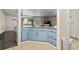 Kitchen view showcasing blue cabinets, stainless appliances, and an open layout to the living spaces at 2805 N Ocean Blvd. # 214, Myrtle Beach, SC 29577