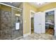 Modern bathroom featuring a tile shower with a glass door, as well as a view to the bedroom at 4808 Cantor Ct., North Myrtle Beach, SC 29582