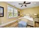 Inviting bedroom featuring a decorative ceiling fan, plantation shutters, and hardwood flooring at 4808 Cantor Ct., North Myrtle Beach, SC 29582