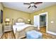 Inviting bedroom featuring a decorative ceiling fan, plantation shutters, and hardwood flooring at 4808 Cantor Ct., North Myrtle Beach, SC 29582