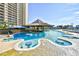 Resort-style pool with a swim-up bar and surrounding lounge areas, perfect for relaxation and entertainment at 4808 Cantor Ct., North Myrtle Beach, SC 29582
