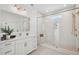 Bright bathroom featuring a double sink vanity, glass shower, and gold fixtures at 1099 Milford Way, Myrtle Beach, SC 29588