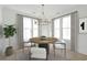 Cozy dining room with round table, modern chandelier, and ample natural light from surrounding windows at 1099 Milford Way, Myrtle Beach, SC 29588