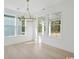 Bright, empty dining room with hardwood floors, lots of light from large windows, and an elegant chandelier at 1099 Milford Way, Myrtle Beach, SC 29588