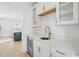 Bright, modern kitchen featuring white cabinets, quartz countertops, wine fridge, and gold hardware at 1099 Milford Way, Myrtle Beach, SC 29588