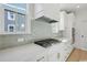 Bright kitchen featuring white cabinets, quartz countertops, gold hardware, and a modern tile backsplash at 1099 Milford Way, Myrtle Beach, SC 29588
