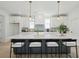 Bright, modern kitchen with a large island, seating, white cabinets, gold hardware, and stylish decor at 1099 Milford Way, Myrtle Beach, SC 29588