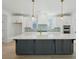 Bright, modern kitchen with a large island, white cabinets, gold hardware, and stainless steel appliances at 1099 Milford Way, Myrtle Beach, SC 29588