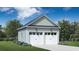 Detached two-car garage with white doors and green siding at 1099 Milford Way, Myrtle Beach, SC 29588