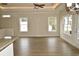 Spacious living room with hardwood floors and multiple windows at 110 Hallandale Lane, Murrells Inlet, SC 29576