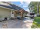 Relaxing backyard patio with pergola, seating area, and outdoor TV at 118 Sly Fox Trail, Myrtle Beach, SC 29588