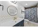 Stylish bathroom with navy vanity and patterned shower curtain at 118 Sly Fox Trail, Myrtle Beach, SC 29588