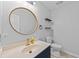 Modern powder room with a round mirror and navy blue vanity at 118 Sly Fox Trail, Myrtle Beach, SC 29588