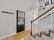 Bright entryway with a black door, stairs, and wood flooring at 118 Sly Fox Trail, Myrtle Beach, SC 29588