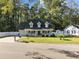 Attractive two-story house with a spacious lawn and a white fence at 118 Sly Fox Trail, Myrtle Beach, SC 29588