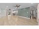 Open living space with light wood floors, green accent wall and kitchen access at 118 Sly Fox Trail, Myrtle Beach, SC 29588
