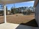 View from the covered patio overlooking the expansive backyard with a serene pond, showcasing outdoor living potential at 216 Palmetto Sand Loop, Conway, SC 29527