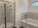 Bathroom with tub and tiled shower with glass door at 216 Palmetto Sand Loop, Conway, SC 29527