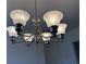 Elegant chandelier with frosted glass shades and brushed nickel finish provides ambient lighting to dining or living area at 216 Palmetto Sand Loop, Conway, SC 29527