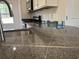 Detailed shot of granite countertops, stainless steel appliances offering durable surfaces and modern appeal in the kitchen at 216 Palmetto Sand Loop, Conway, SC 29527