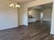 Open-concept dining area with hardwood floors, stylish chandelier, and seamless flow into the kitchen at 216 Palmetto Sand Loop, Conway, SC 29527