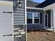 A close-up highlighting the architectural details, including stone accents, siding, window trim, and garage door design at 216 Palmetto Sand Loop, Conway, SC 29527