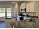 Modern kitchen with granite countertops, stainless steel appliances and white cabinets for stylish cooking and convenience at 216 Palmetto Sand Loop, Conway, SC 29527