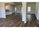 Spacious living area with hardwood floors, open floor plan, natural light, and seamless flow into the kitchen at 216 Palmetto Sand Loop, Conway, SC 29527