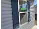 Close-up of a window with blue shutters and an 'Available' sign, indicating property status and details at 216 Palmetto Sand Loop, Conway, SC 29527