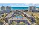Panoramic aerial view showcasing the condo complex's pool, tennis court, and proximity to the beach at 212 2Nd Ave. N # 364, North Myrtle Beach, SC 29582
