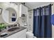Bathroom with granite countertop, modern vanity, and shower with navy blue curtain at 212 2Nd Ave. N # 364, North Myrtle Beach, SC 29582