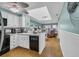 Open-concept kitchen features white cabinets, modern appliances, and connects to the living area at 212 2Nd Ave. N # 364, North Myrtle Beach, SC 29582