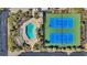 Aerial view of a swimming pool and tennis courts with lush landscaping at 212 2Nd Ave. N # 364, North Myrtle Beach, SC 29582
