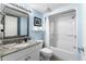 Well-lit bathroom features a granite vanity, framed mirror and tub-shower combo with curtain at 3000 N Ocean Blvd. # 1601, Myrtle Beach, SC 29577
