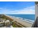 Sweeping ocean view showcases a long sandy beach along a beautiful coastline under a blue sky at 3000 N Ocean Blvd. # 1601, Myrtle Beach, SC 29577