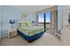 Inviting bedroom with tropical themed bedspread, ample natural light and blue accent walls at 3000 N Ocean Blvd. # 1601, Myrtle Beach, SC 29577