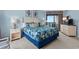 Comfortable bedroom with a king-sized bed, blue accents, and balcony access with ocean views at 3000 N Ocean Blvd. # 1601, Myrtle Beach, SC 29577