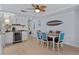 Cozy dining area with coastal decor, a ceiling fan, and an adjacent kitchenette with bar at 3000 N Ocean Blvd. # 1601, Myrtle Beach, SC 29577