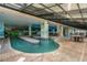 Spacious indoor pool area with tables and chairs, perfect for year-round enjoyment at 3000 N Ocean Blvd. # 1601, Myrtle Beach, SC 29577