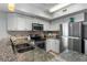 Bright kitchen featuring stainless steel appliances, granite counters, and white cabinetry at 3000 N Ocean Blvd. # 1601, Myrtle Beach, SC 29577