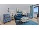 Cozy living room with stylish blue furniture, decor, and access to balcony at 3000 N Ocean Blvd. # 1601, Myrtle Beach, SC 29577