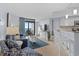 Bright living room with blue accents, modern furniture, and balcony access with ocean views at 3000 N Ocean Blvd. # 1601, Myrtle Beach, SC 29577