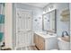Charming bathroom featuring a vanity with sink, decorative mirror, and linen closet at 328 S Waccamaw Dr., Garden City Beach, SC 29576