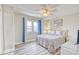 Bright bedroom with full bed, colorful quilt, and window with view at 328 S Waccamaw Dr., Garden City Beach, SC 29576
