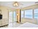 Inviting bedroom with ocean view, sliding glass door to balcony, and neutral decor at 328 S Waccamaw Dr., Garden City Beach, SC 29576